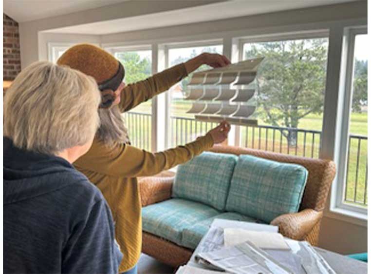 Holding up fabric samples to a window